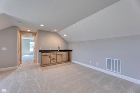 Bonus room at 14832 Higgins Drive, Westfield, IN — Spacious bonus room with wet bar and vaulted ceiling.