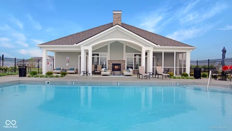 Outdoor living area at 14832 Higgins Drive, Westfield, IN — Luxurious resort-style pool with modern pool house.