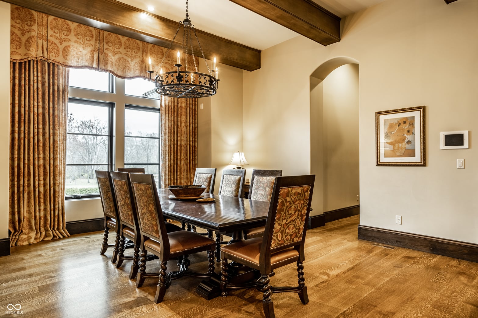 Formal dining room with elegant traditional design and natural light.