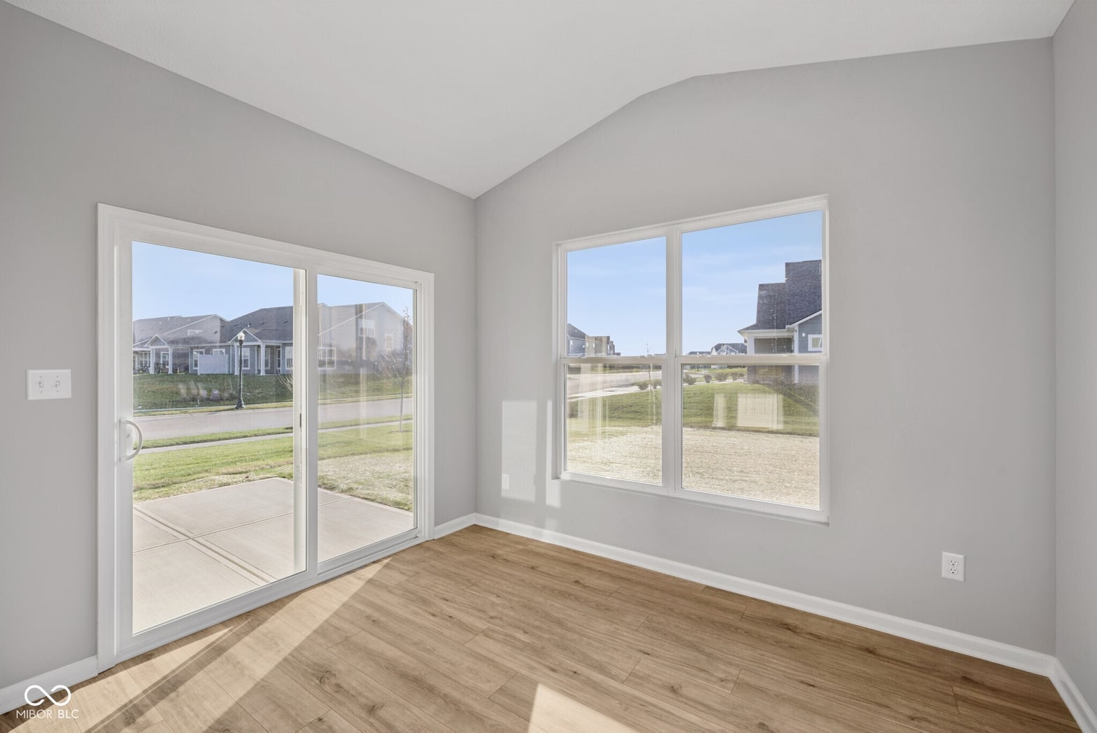 Bright contemporary space with expansive windows and patio access.