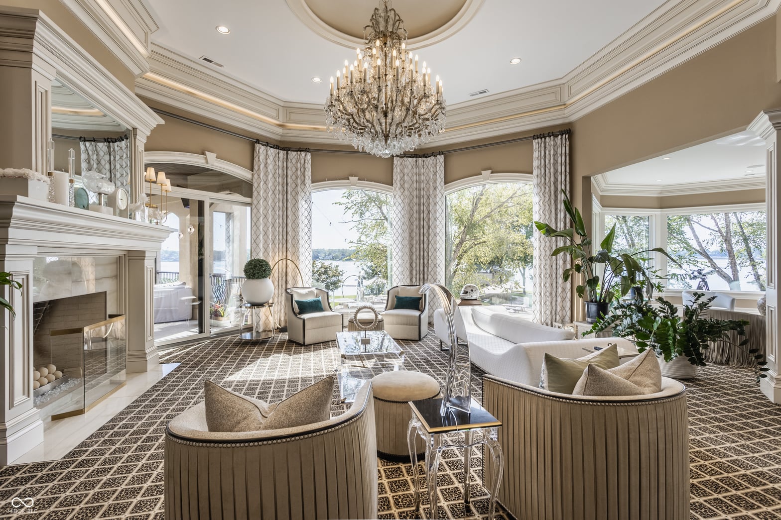 Luxurious spa-like primary bath with fireplace and water views.