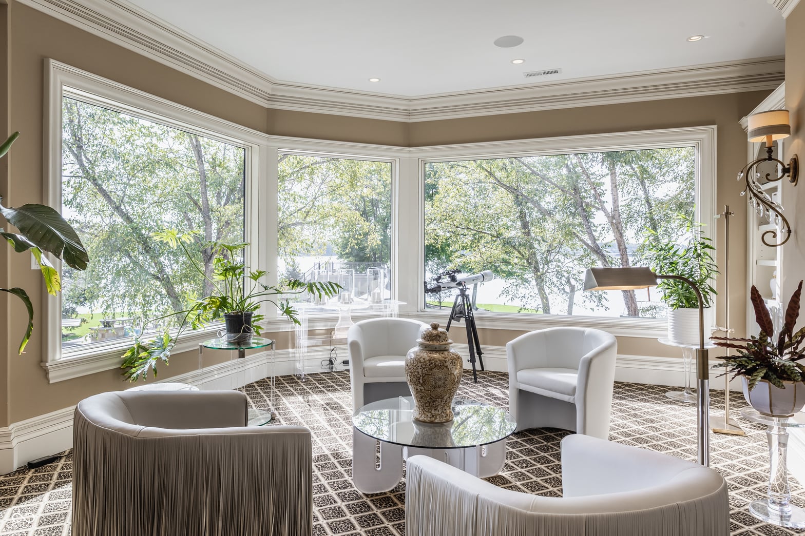 Bright bay window living room with elegant curved furnishings.