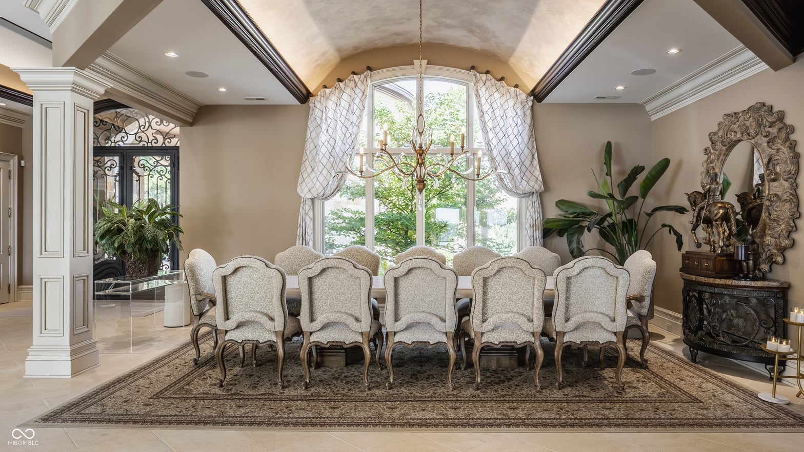Sophisticated dining room with barrel vault ceiling and arched windows.