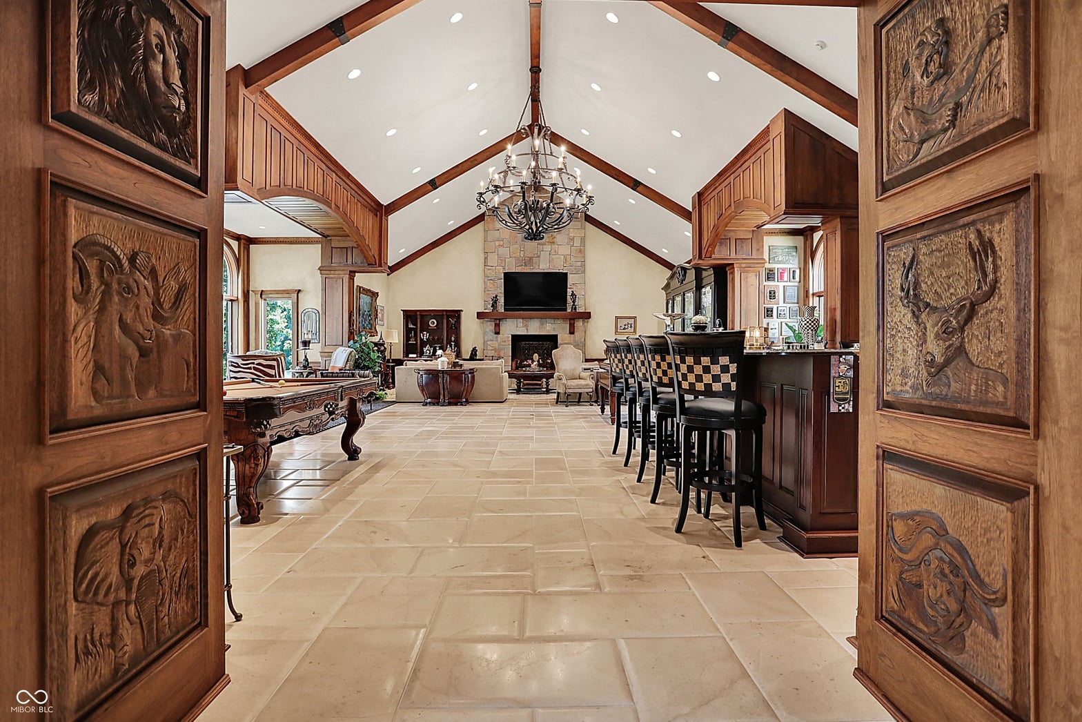 Luxurious open-concept great room with soaring beamed ceilings.