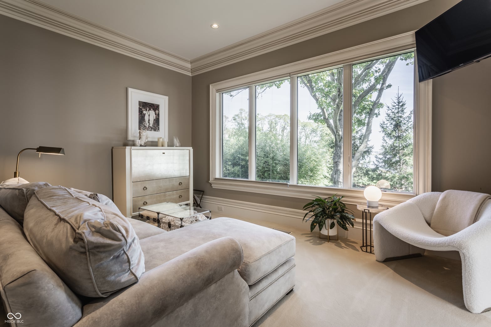 Spacious primary bedroom with expansive windows and natural light.