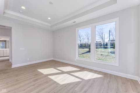 Bedroom at 16098 Quarter Pole Lane, Westfield, IN — Bright bedroom with expansive windows and tray ceiling.