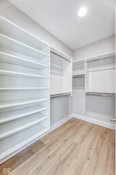 Bonus room at 16098 Quarter Pole Lane, Westfield, IN — Spacious walk-in closet with custom white shelving.