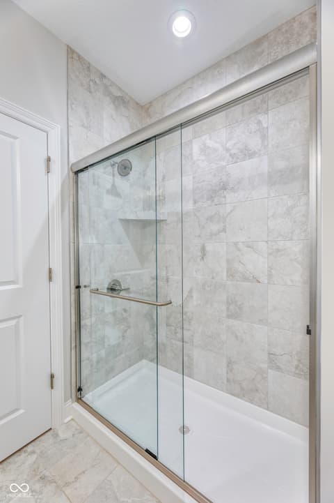 Primary bathroom at 16098 Quarter Pole Lane, Westfield, IN — Luxurious spa-like bathroom with frameless glass shower.
