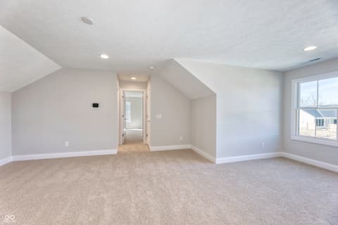 Bonus room at 16098 Quarter Pole Lane, Westfield, IN — Spacious bonus room with vaulted ceilings and natural light.