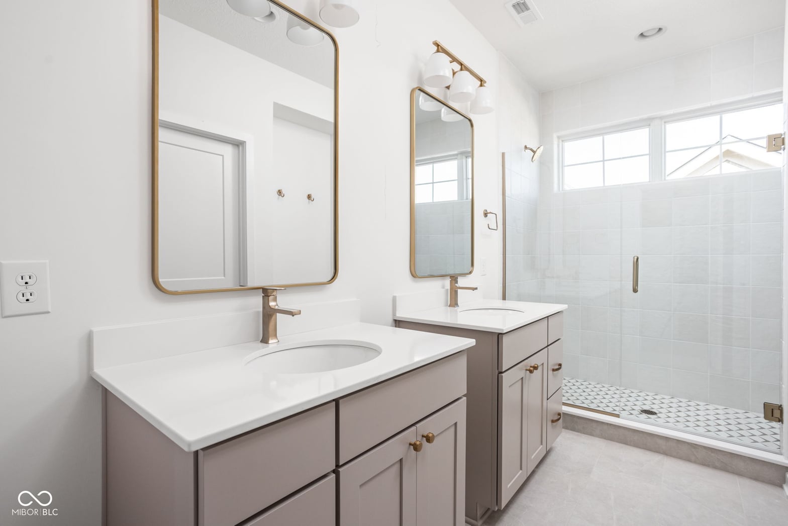 Luxurious primary bath with dual vanity and walk-in shower.