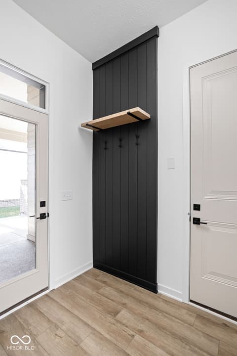 Foyer at 17334 Ditch Road, Westfield, IN — Stylish foyer with black shiplap accent and floating shelf.