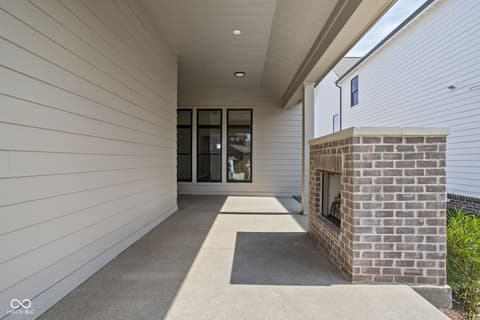 Front exterior at 17334 Ditch Road, Westfield, IN — Spacious covered front porch with modern finishes.