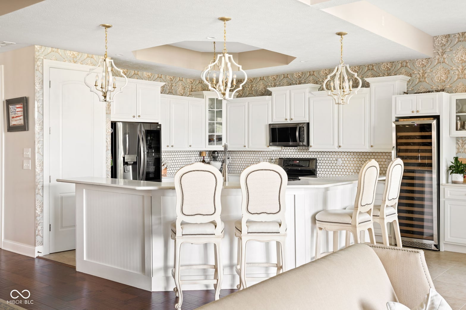 Luxurious white kitchen with large island and premium finishes.