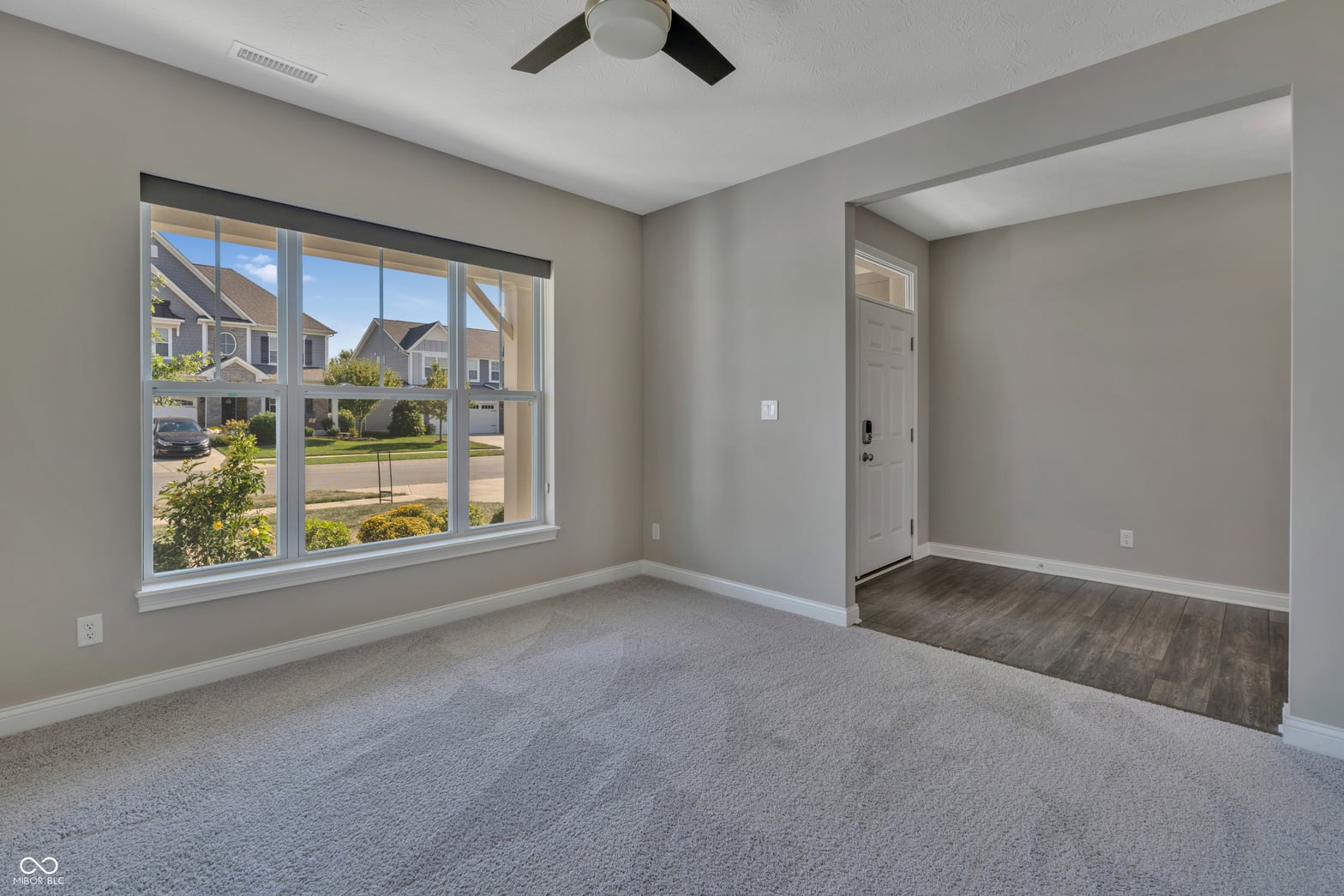 Bright primary suite with expansive window and ensuite access.