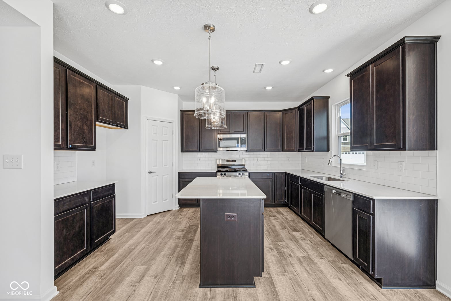 Modern kitchen with dark cabinetry and bright white finishes