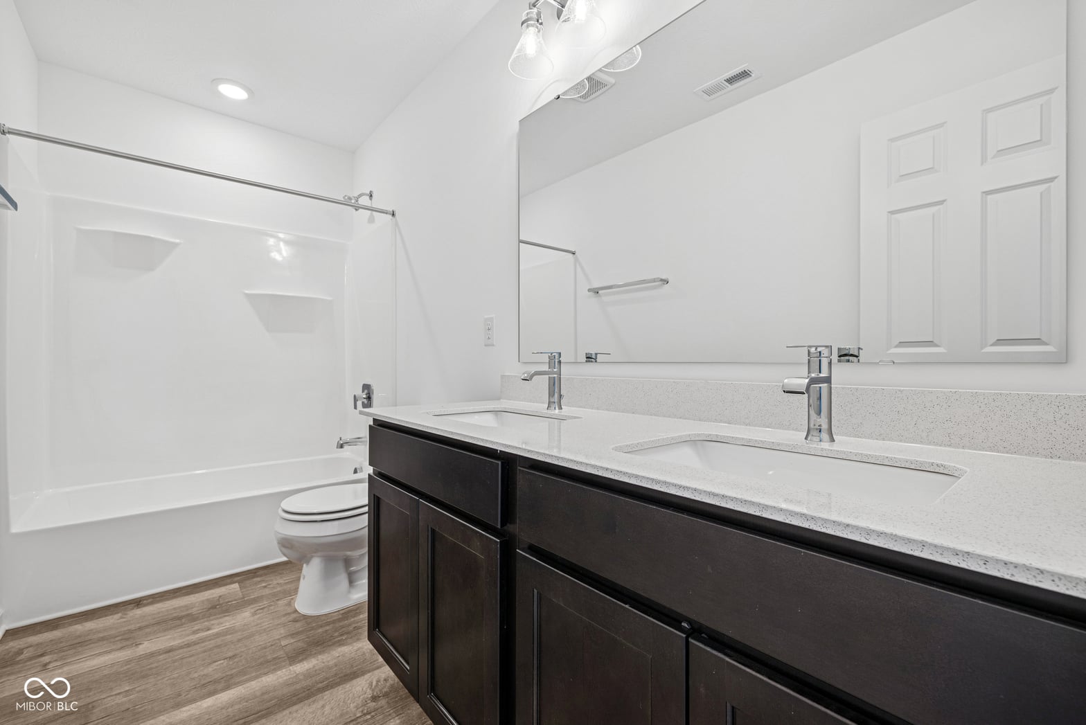 Luxurious primary bath with dual vanity and soaking tub.