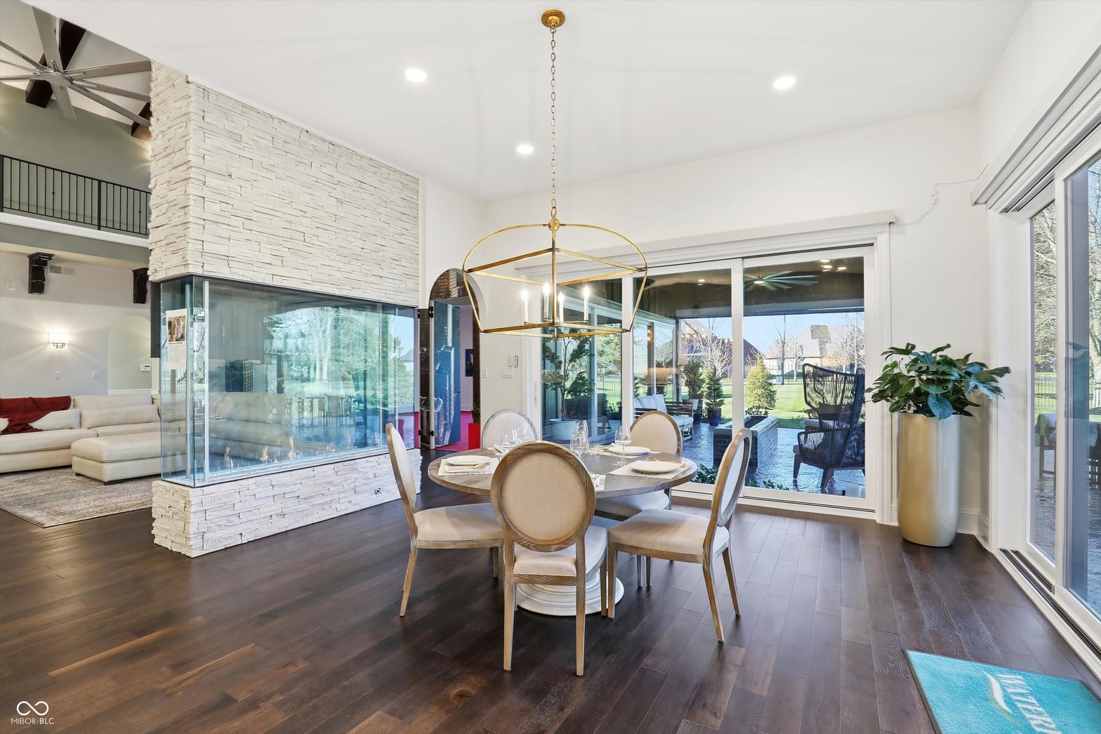 Bright contemporary dining with fireplace and outdoor views.