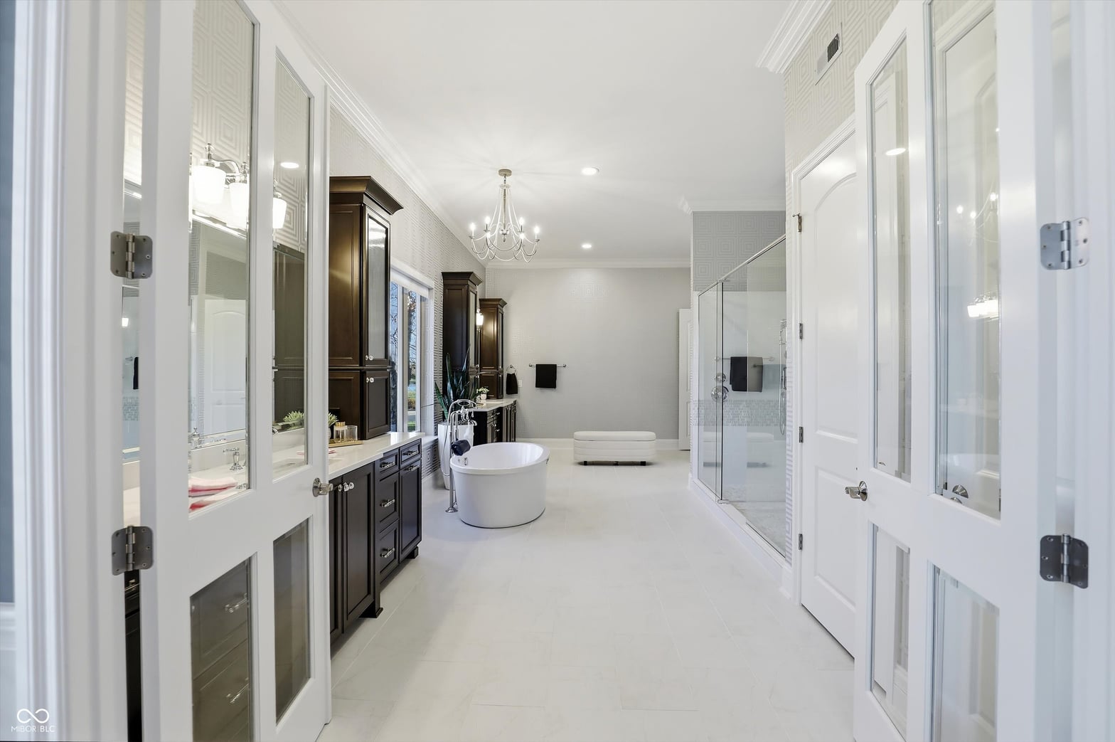 Luxurious primary bath with dual vanity and soaking tub.