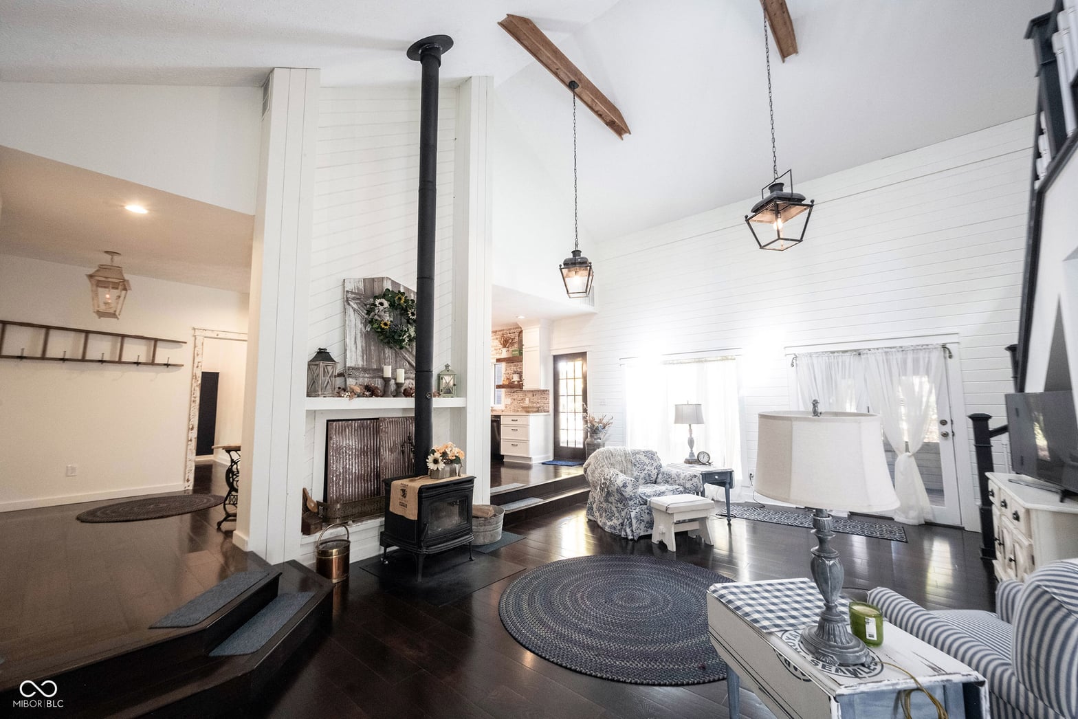 Stunning farmhouse family room with wood stove and shiplap.