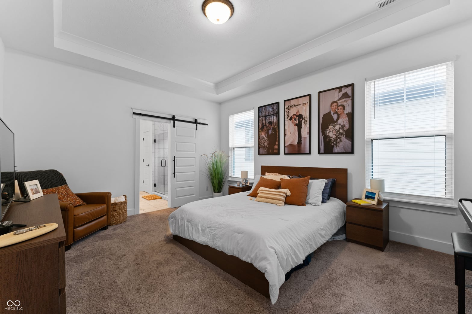 Spacious primary bedroom with coffered ceilings and ensuite.