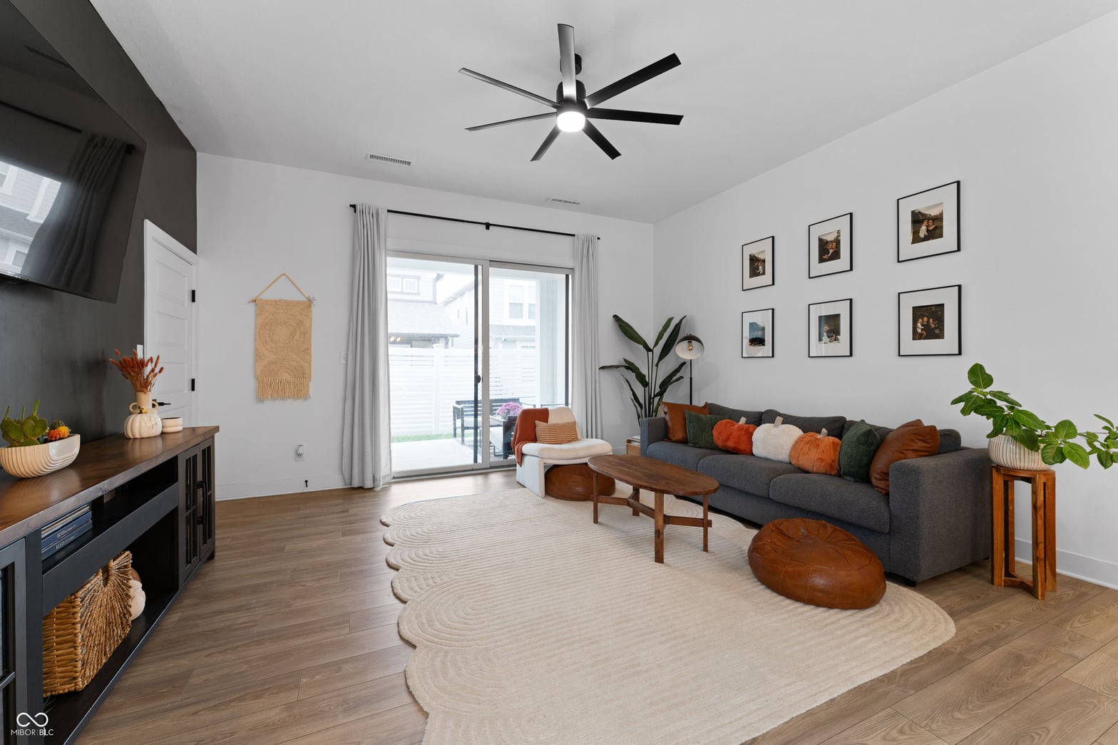 Modern living space with hardwood floors and fireplace.