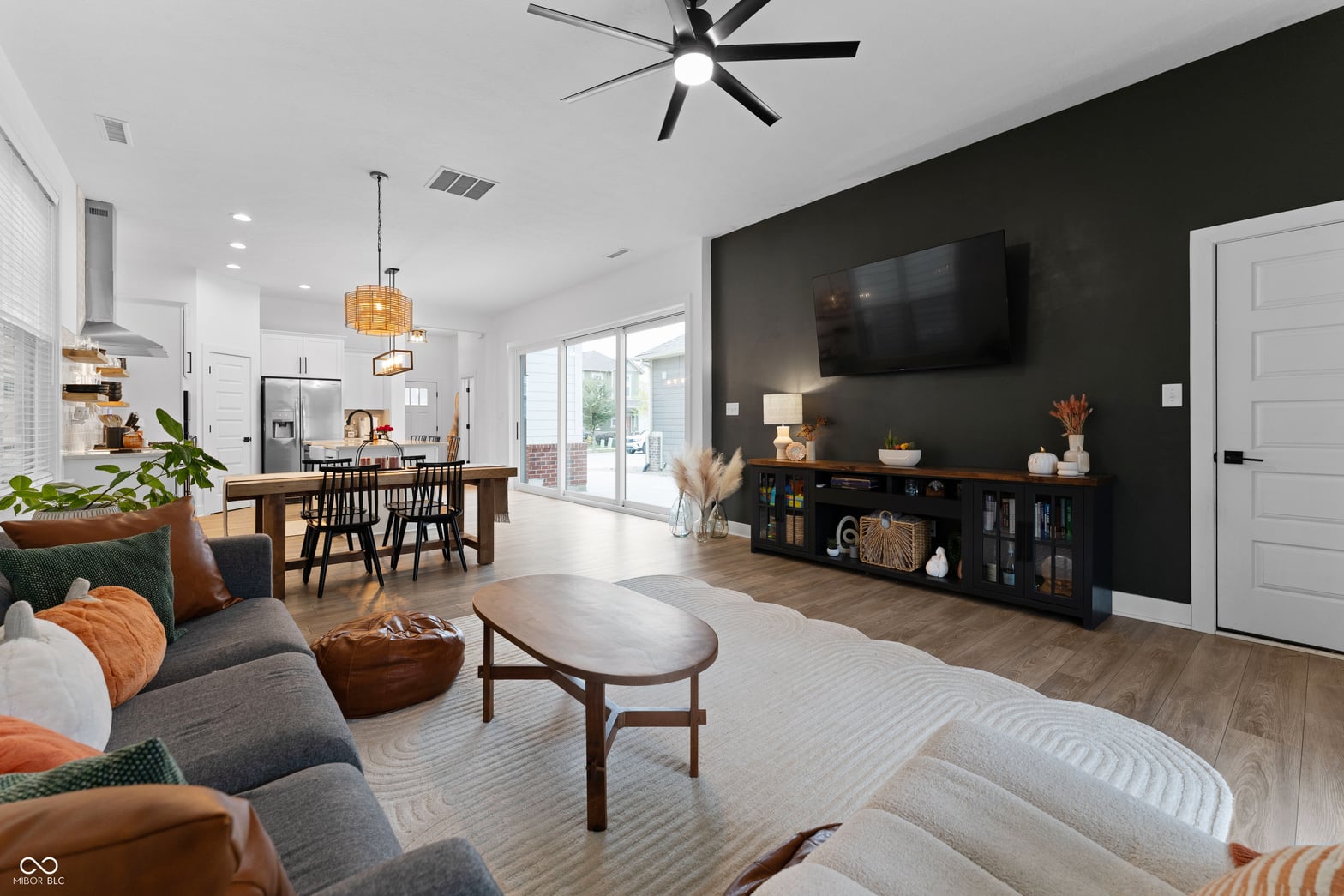 Modern open-concept living with stylish dark accent wall.