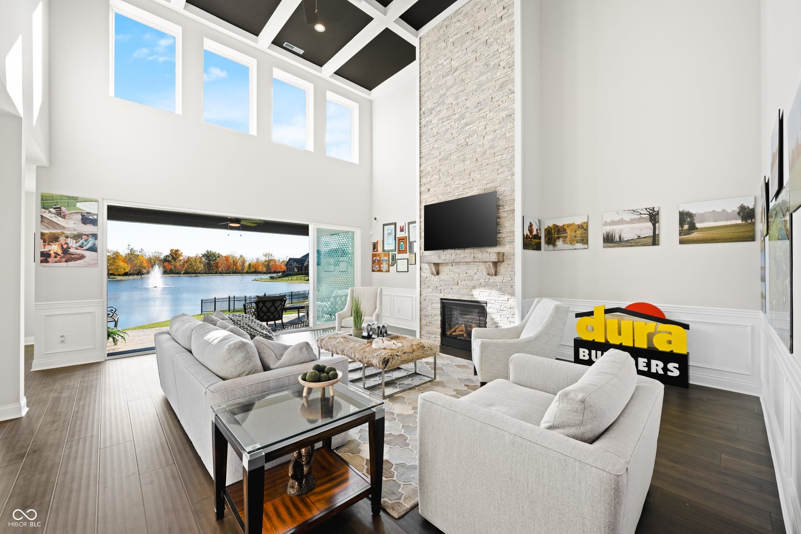 Living room at 4301 Stone Lake Drive, Zionsville, IN — Waterfront living room with soaring ceilings and fireplace.
