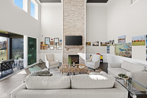 Living room at 4301 Stone Lake Drive, Zionsville, IN — Bright living room with soaring ceilings and fireplace.