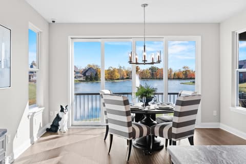 Dining room at 4301 Stone Lake Drive, Zionsville, IN — Stunning waterfront dining with expansive lake views.