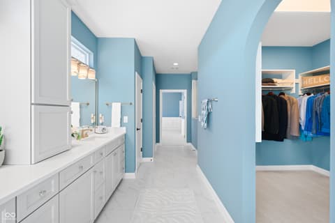 Primary bathroom at 4301 Stone Lake Drive, Zionsville, IN — Spa-like primary bath with dual vanity and walk-in closet.