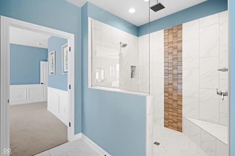 Primary bathroom at 4301 Stone Lake Drive, Zionsville, IN — Luxurious primary bath with marble walk-in shower.