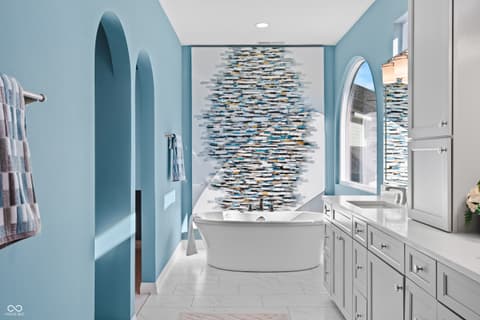 Primary bathroom at 4301 Stone Lake Drive, Zionsville, IN — Spa-like primary bath with soaking tub and accent wall.