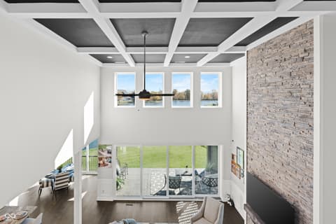 Living room at 4301 Stone Lake Drive, Zionsville, IN — Modern living room with coffered ceiling and water views.