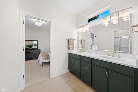 Primary bathroom at 4301 Stone Lake Drive, Zionsville, IN — Luxurious primary bath with dual vanity and modern finishes.