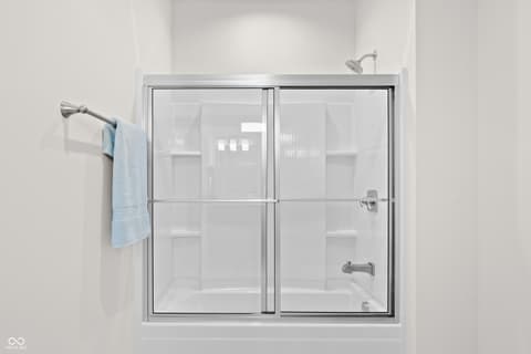 Primary bathroom at 4301 Stone Lake Drive, Zionsville, IN — Clean modern shower with frameless glass enclosure.
