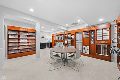 Bonus room at 4301 Stone Lake Drive, Zionsville, IN — Luxurious showroom with custom wood cabinetry and displays.