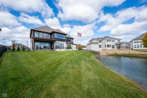 Backyard at 4301 Stone Lake Drive, Zionsville, IN — Stunning waterfront home with pristine lawn and pond views.