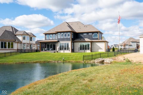Backyard at 4301 Stone Lake Drive, Zionsville, IN — Stunning waterfront home with expansive pond views.