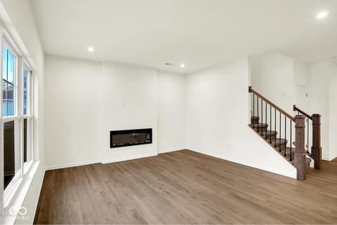 Family room at 3746 Thomas Jefferson Court, Westfield, IN — Modern family room with contemporary linear fireplace.