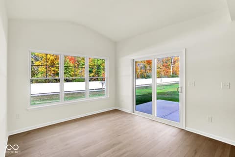 Family room at 3746 Thomas Jefferson Court, Westfield, IN — Bright room with expansive windows and patio doors.