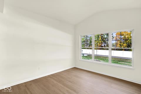 Bedroom at 3746 Thomas Jefferson Court, Westfield, IN — Bright bedroom with expansive windows and hardwood floors.
