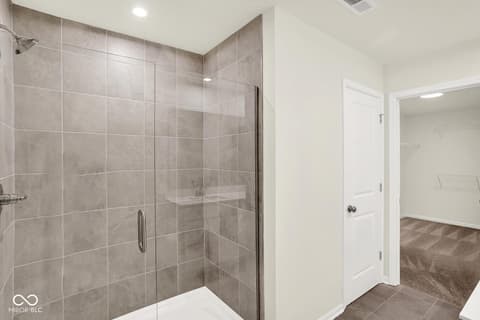 Primary bathroom at 3746 Thomas Jefferson Court, Westfield, IN — Spacious primary bath with frameless glass shower.
