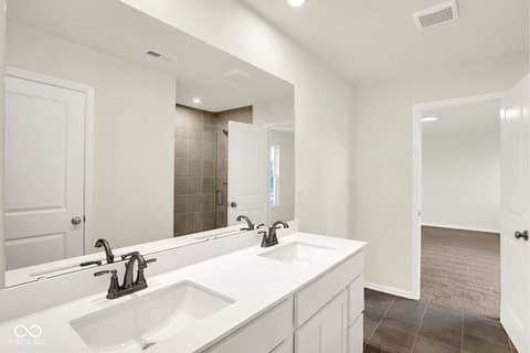 Primary bathroom at 3746 Thomas Jefferson Court, Westfield, IN — Luxurious primary bath with dual vanity and spa shower.