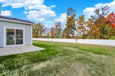 Backyard at 3746 Thomas Jefferson Court, Westfield, IN — Spacious fenced backyard with mature trees and patio.