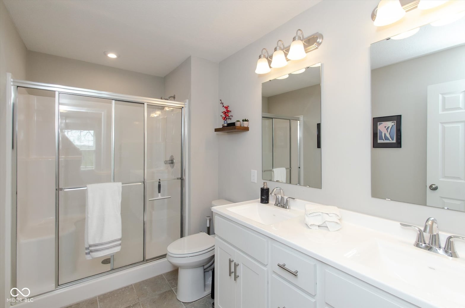 Spa-like primary bath with double vanity and updated fixtures.