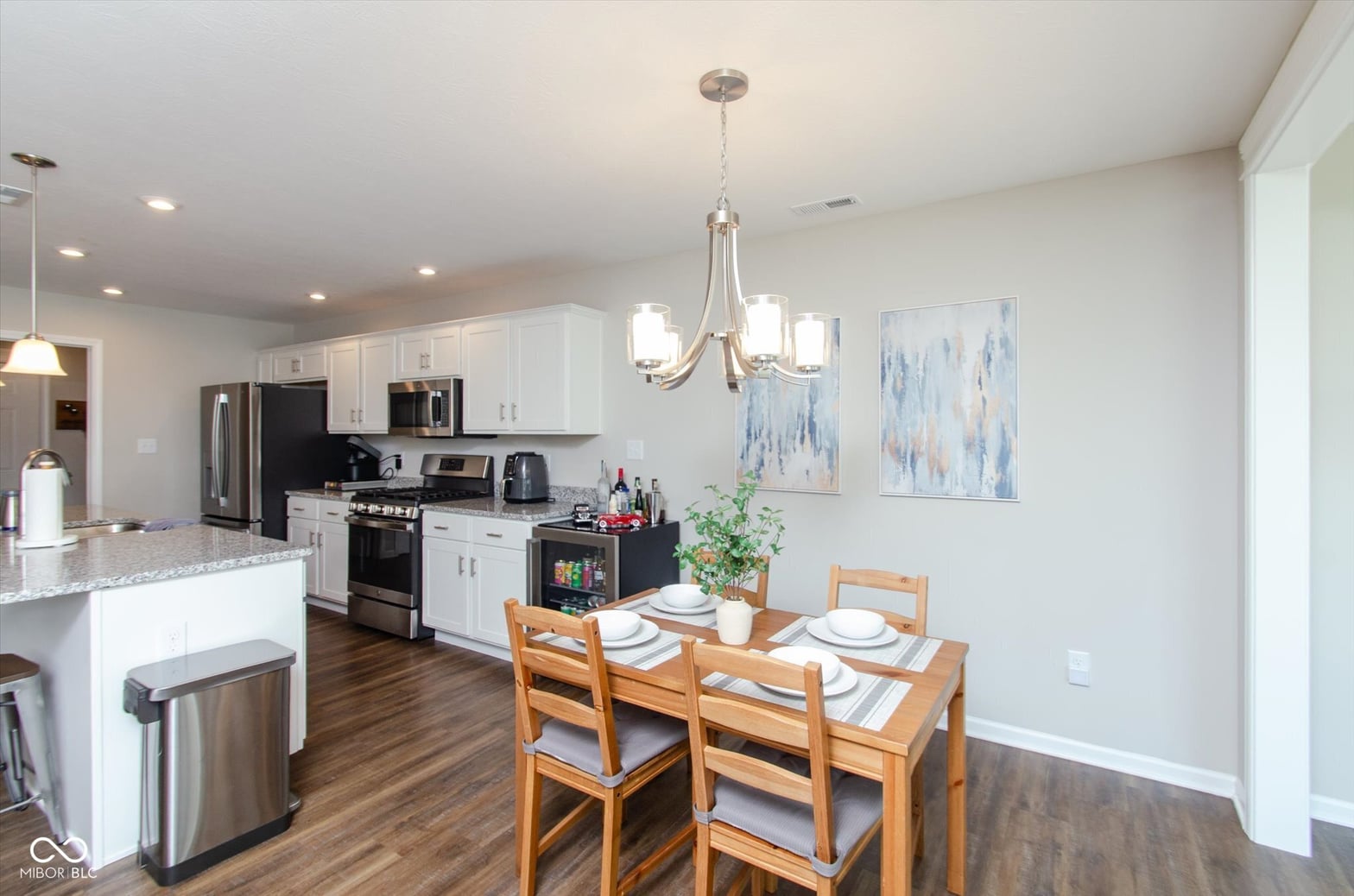 Bright updated kitchen with granite and stainless steel appliances.