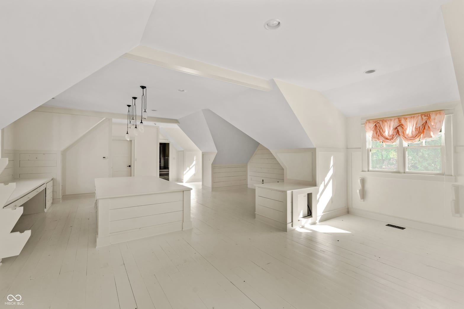 Bright airy primary suite with vaulted ceilings and skylights.