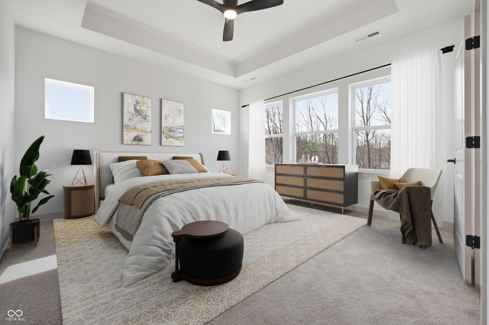 Bright primary suite with expansive windows and tray ceiling.