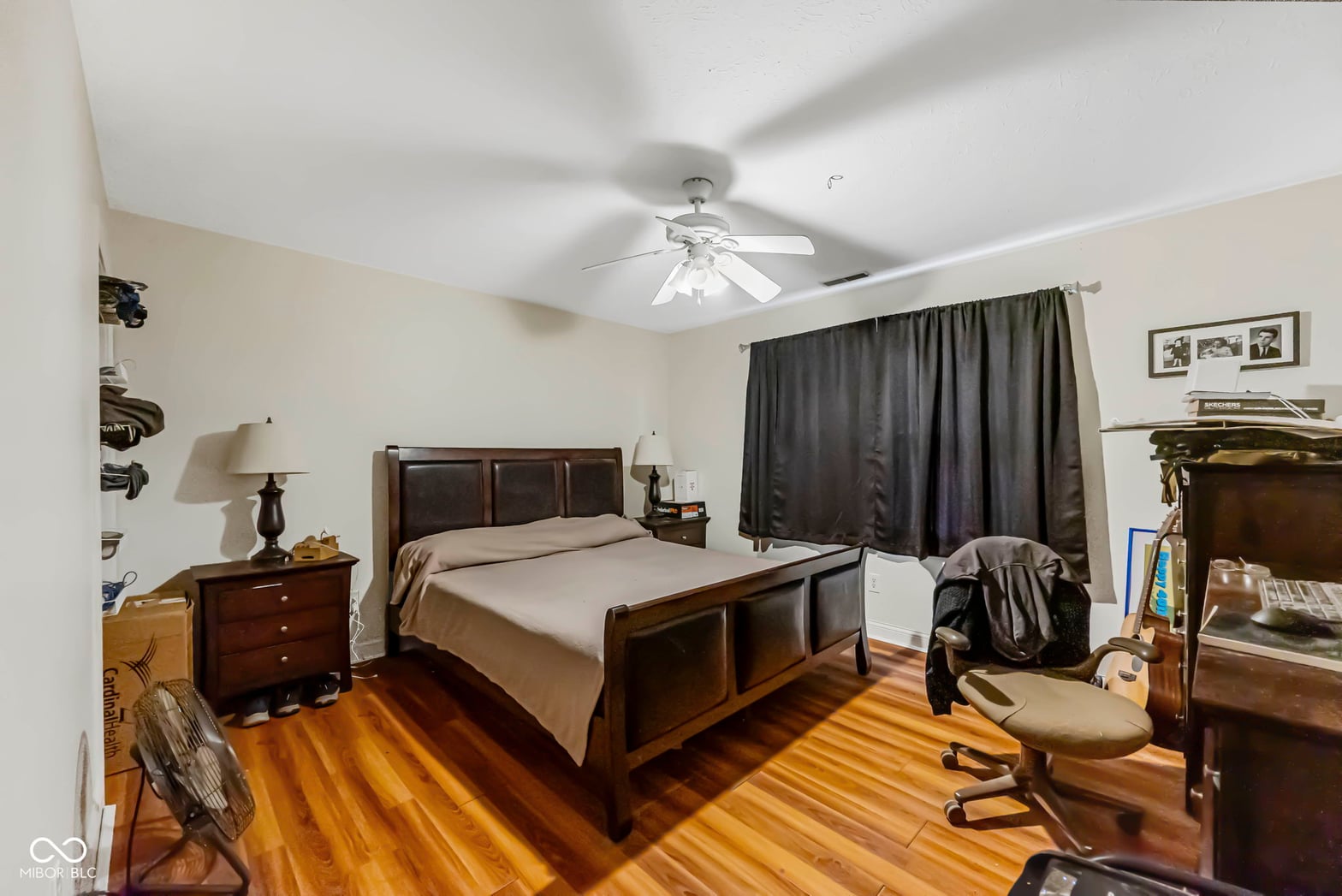 Spacious primary bedroom with hardwood floors and natural light.