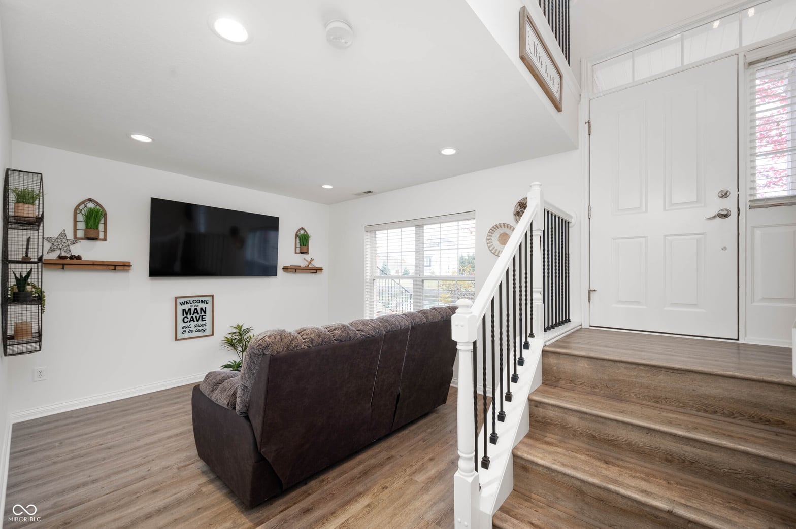 Bright open family room with modern entertainment setup.